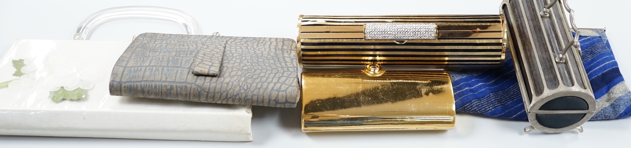 Two 1960's gilt metal ladies evening bags, a metal and wooden bag, a 1950's plastic and fabric bag possibly American, a 1930's faux crocodile clutch bag and a 1930's stripe clutch bag